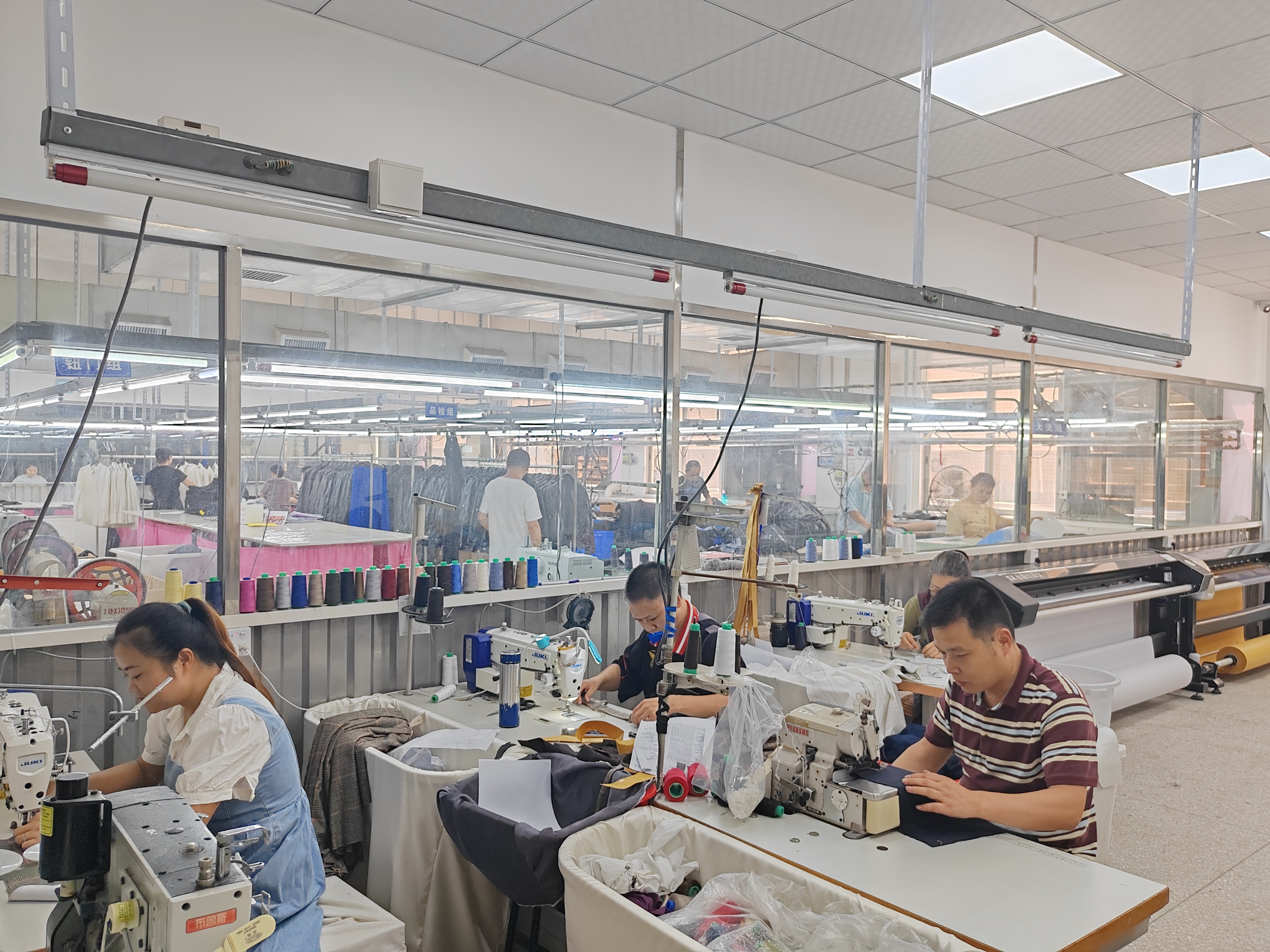 Sewing production floor with operators working on garment lines