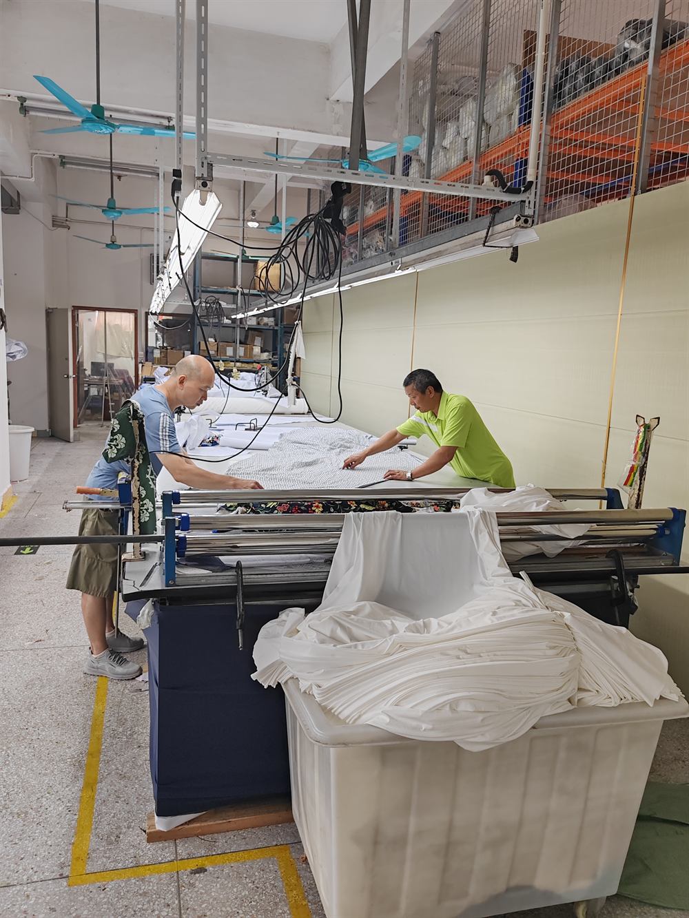 Fabric being prepared on a factory cutting table