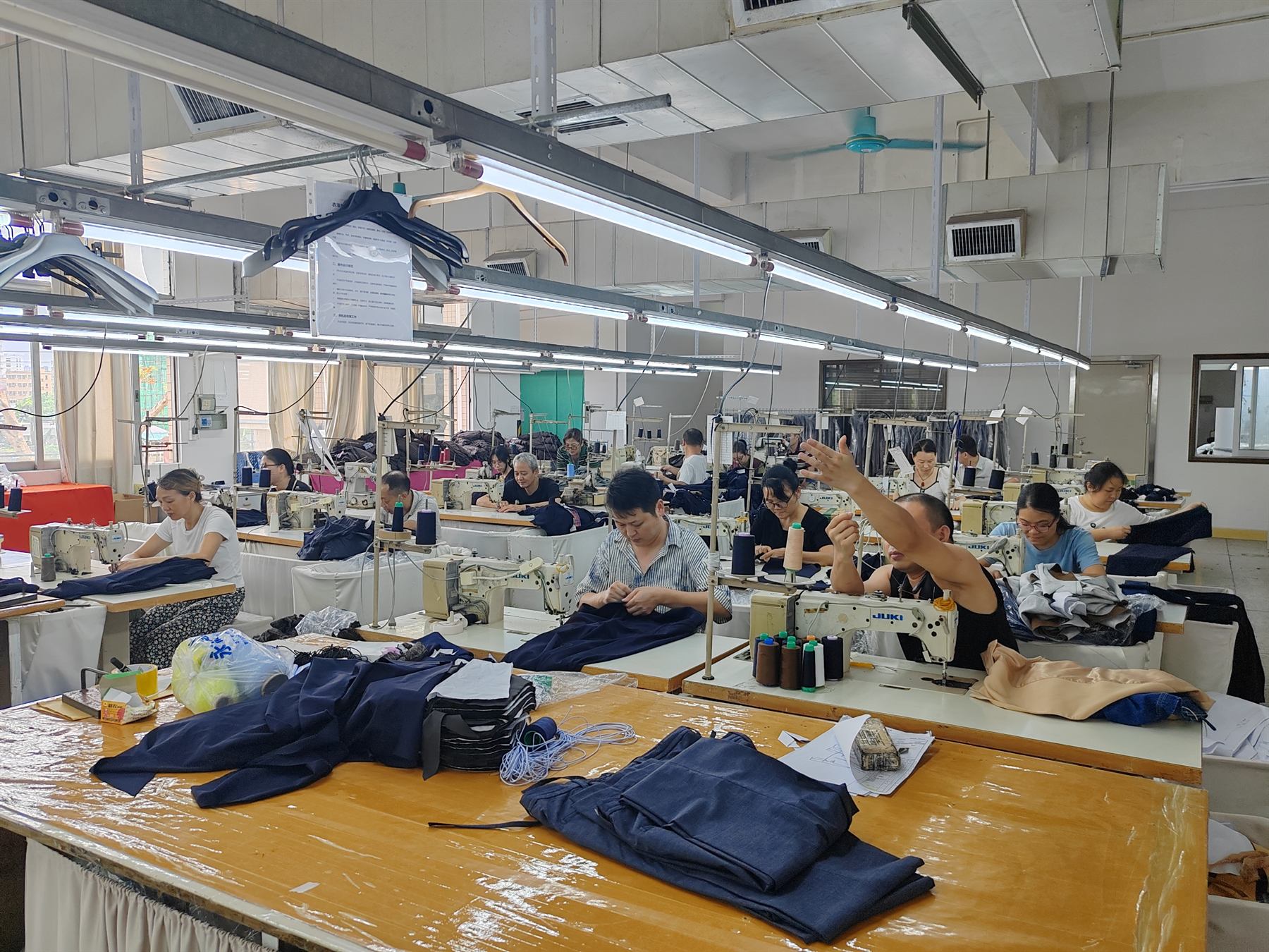 Garment production floor with sewing stations and work in progress