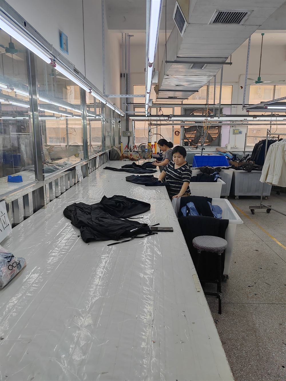 Garments being reviewed on a packing and finishing table