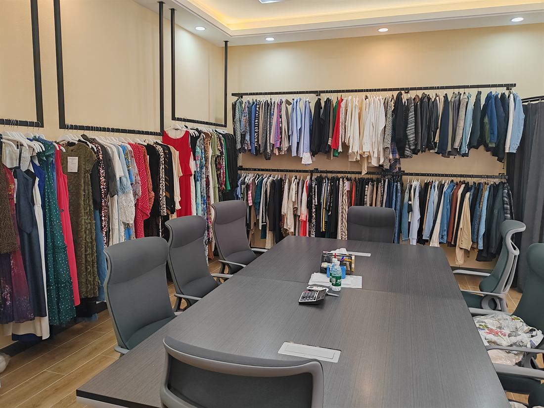 Showroom meeting room with garment sample rails